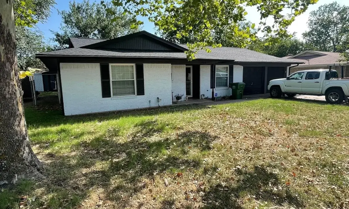 Professional roofing crew working on a residential roof in St. Marys